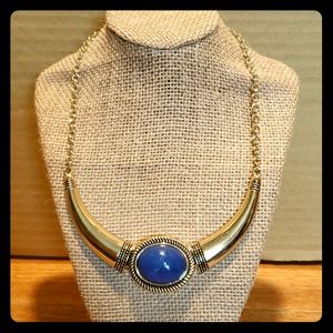 Gold tone necklace with acrylic blue stone